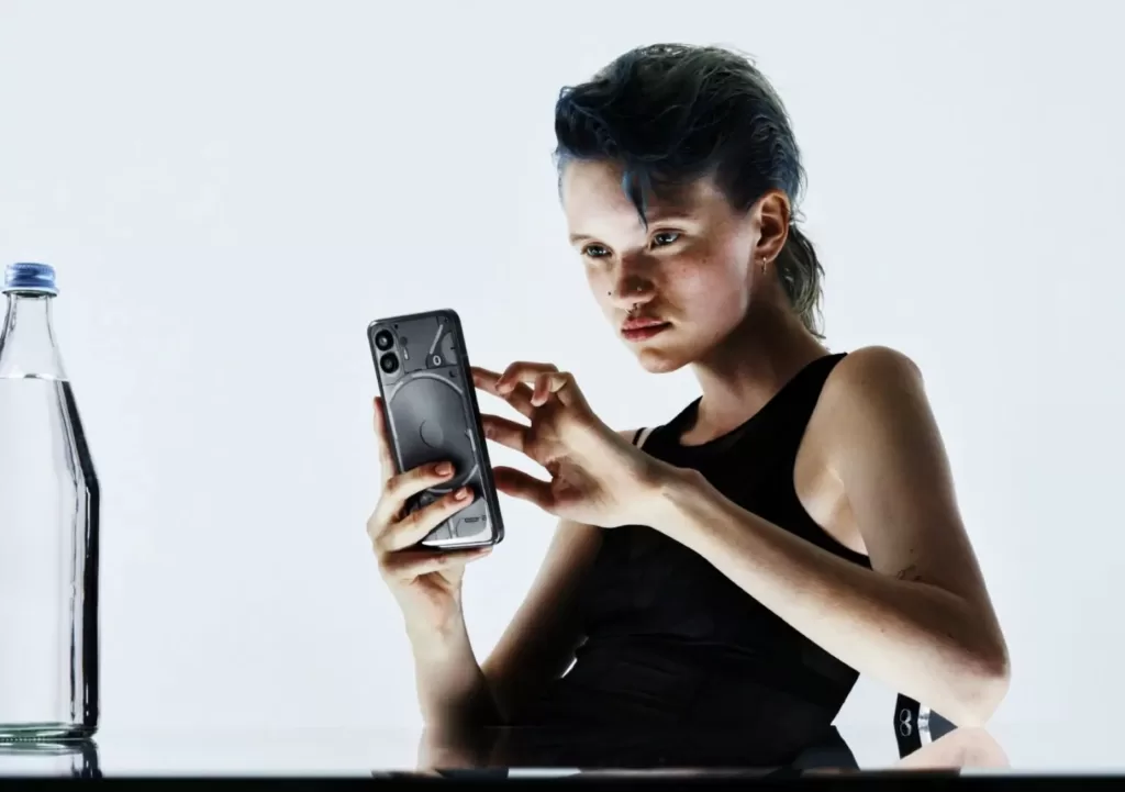 a picture of the a girls holding the nothing phone 2 in dubai.